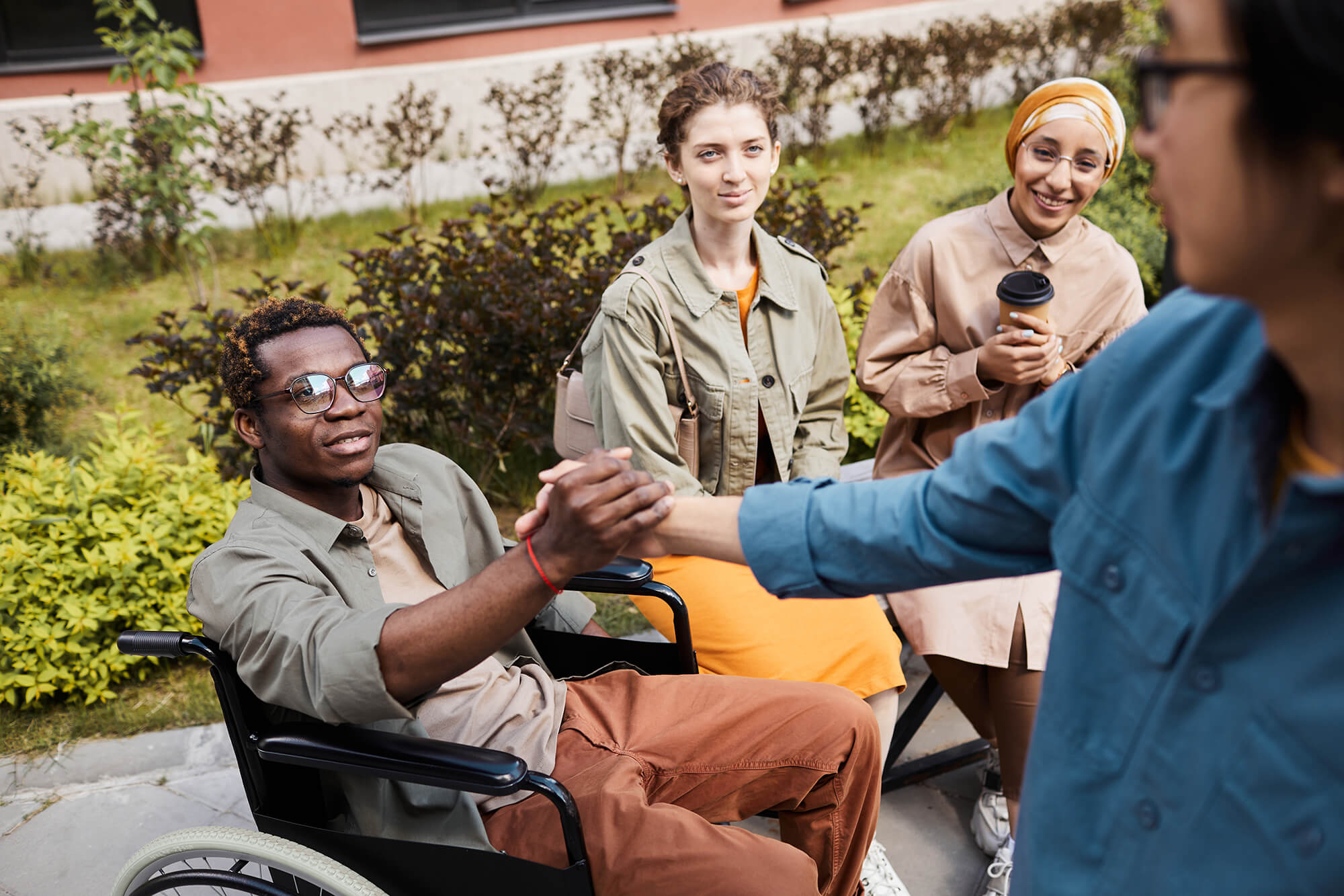 making-handshake-with-man-in-wheelchair-2023-11-27-04-51-53-utc