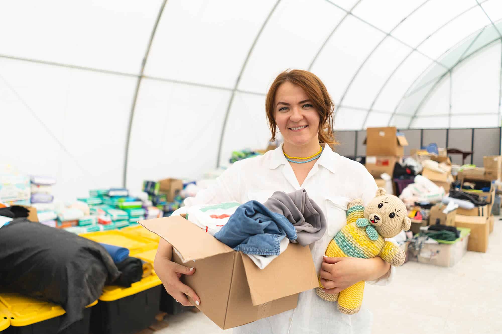 volunteer-woman-preparing-donation-boxes-for-peopl-2024-03-13-17-48-09-utc